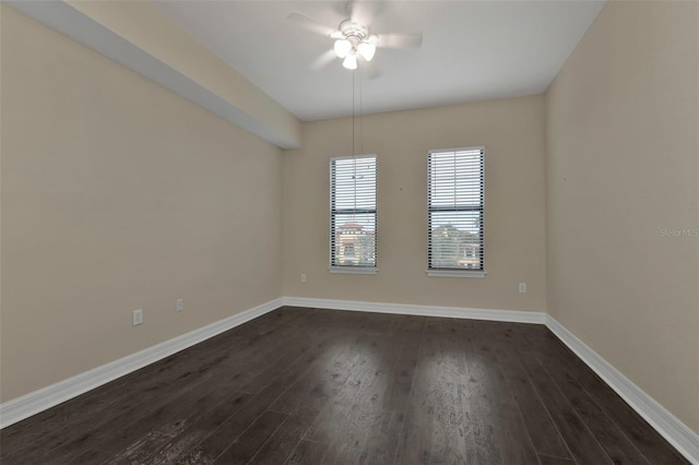 empty room with ceiling fan and dark wood-type flooring