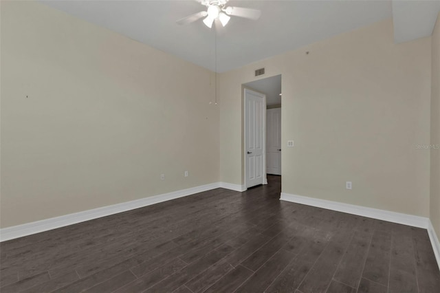 spare room featuring ceiling fan and dark hardwood / wood-style floors