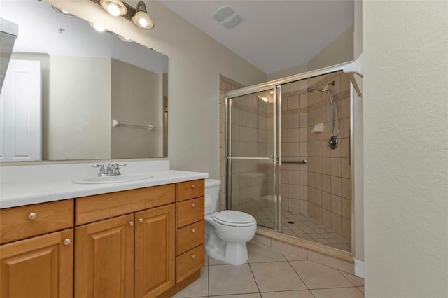 bathroom featuring tile patterned floors, vanity, toilet, and a shower with shower door