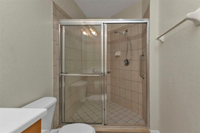 bathroom featuring vanity, toilet, and walk in shower