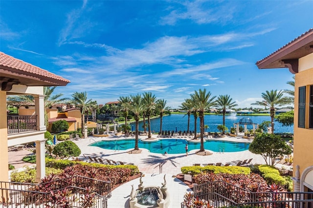 view of swimming pool with a water view and a patio