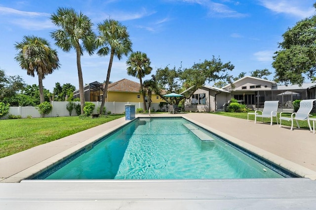 view of swimming pool featuring a patio and a lawn