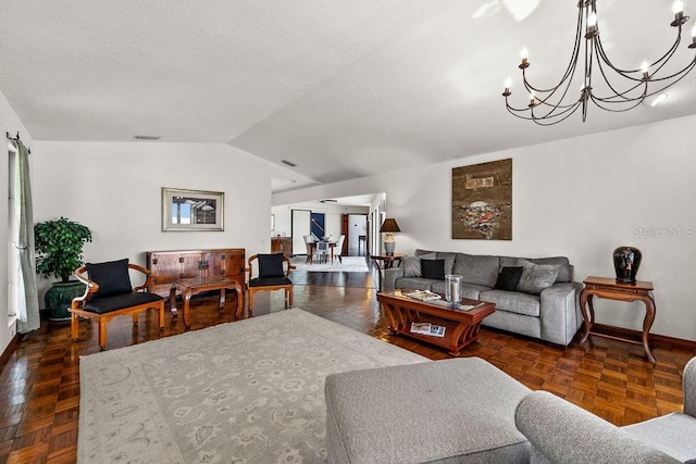 living room featuring a chandelier, dark parquet floors, and lofted ceiling