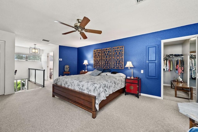 carpeted bedroom with ceiling fan and a closet