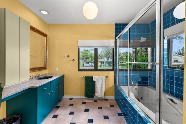 bathroom with vanity, tile patterned floors, and enclosed tub / shower combo