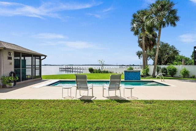 view of pool with a water view and a lawn