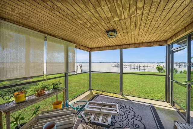 sunroom / solarium with a water view and wood ceiling