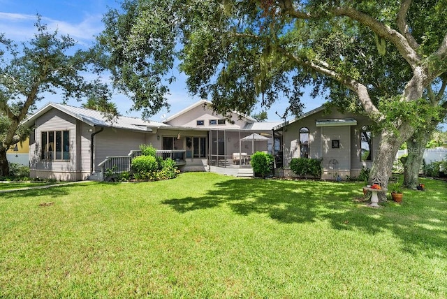 rear view of house with a yard