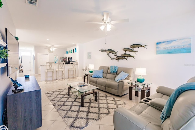 tiled living room featuring ceiling fan