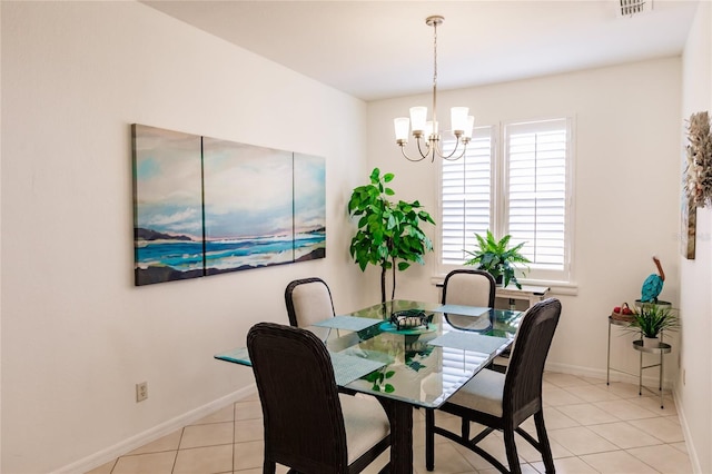 tiled dining space with a chandelier