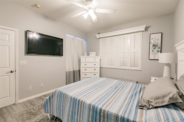 bedroom with ceiling fan and light hardwood / wood-style floors