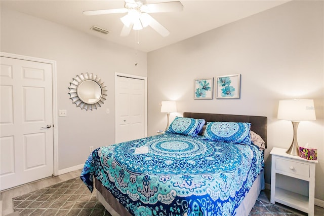 bedroom featuring dark wood-type flooring, ceiling fan, and a closet