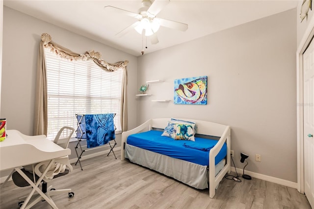 bedroom with light hardwood / wood-style floors and ceiling fan