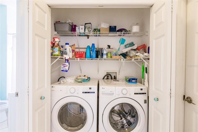 washroom with washing machine and clothes dryer