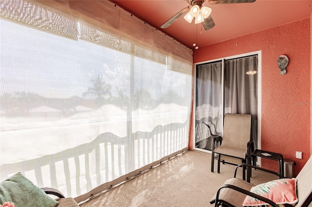 sunroom featuring ceiling fan