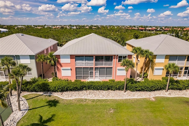 back of property featuring a lawn