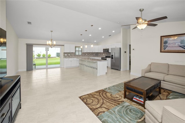 living room featuring light tile patterned flooring, ceiling fan with notable chandelier, sink, and high vaulted ceiling