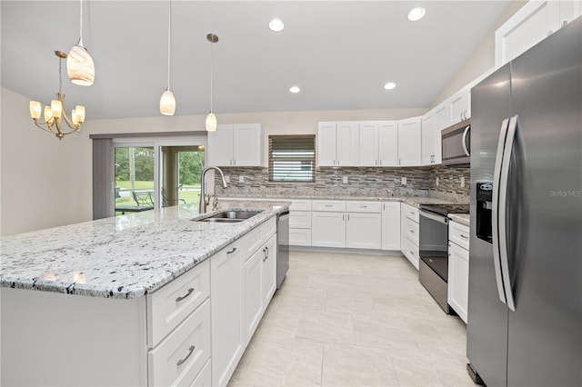 kitchen with white cabinetry, stainless steel appliances, decorative light fixtures, a kitchen island with sink, and sink