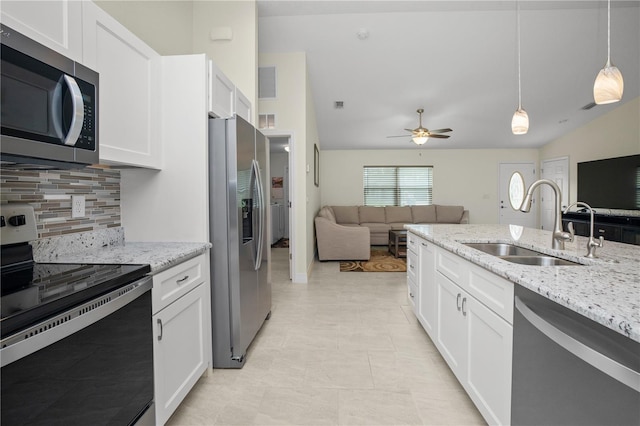 kitchen with sink, white cabinets, hanging light fixtures, appliances with stainless steel finishes, and ceiling fan