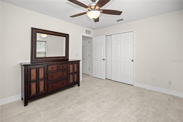 bedroom with light tile patterned floors, ceiling fan, and a closet