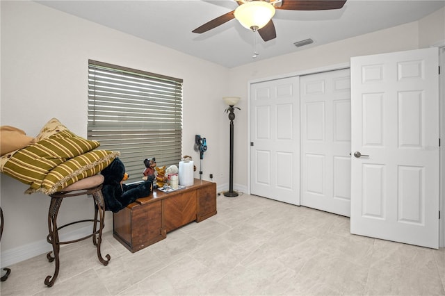 tiled office space with ceiling fan