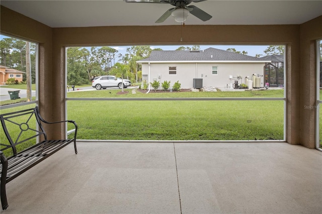 unfurnished sunroom featuring ceiling fan