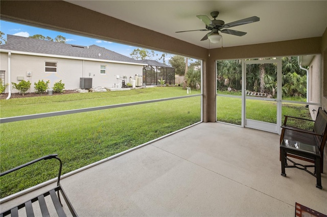 unfurnished sunroom featuring ceiling fan