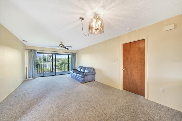 unfurnished living room with ceiling fan with notable chandelier and carpet floors