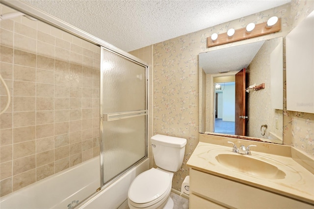 full bathroom with bath / shower combo with glass door, vanity, toilet, and a textured ceiling