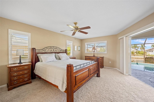 bedroom with ceiling fan, light colored carpet, and access to outside