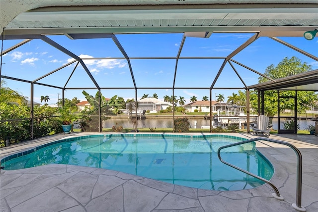 view of swimming pool with glass enclosure, a patio area, and a water view