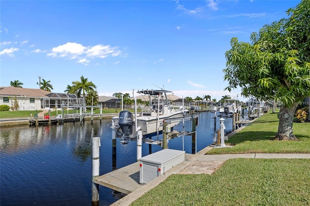 dock area with a yard and a water view