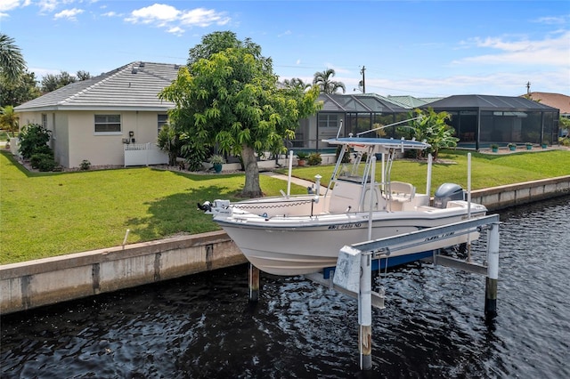 dock area with a water view, glass enclosure, and a lawn