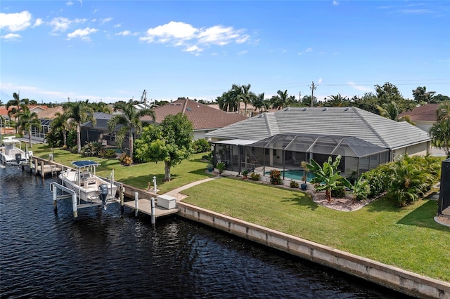 dock area featuring a yard, a water view, and glass enclosure