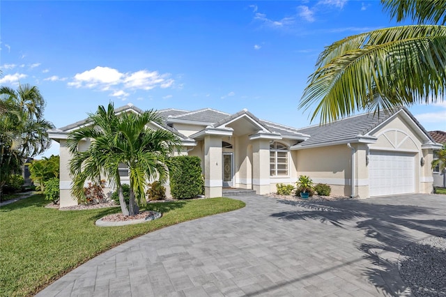 view of front of property with a garage and a front yard