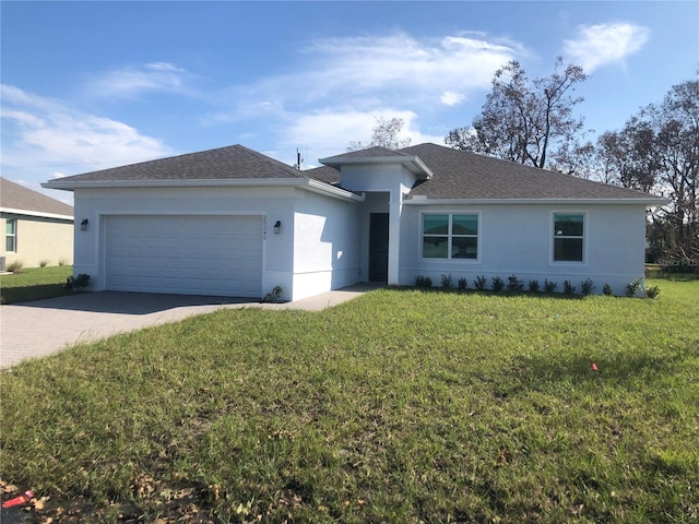 single story home with a garage and a front lawn