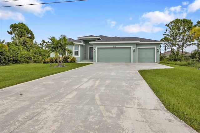 view of front of house with a garage and a front lawn