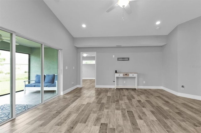 unfurnished living room featuring high vaulted ceiling, light hardwood / wood-style floors, and ceiling fan