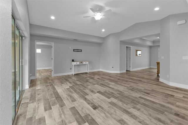 unfurnished living room featuring a healthy amount of sunlight, light hardwood / wood-style floors, and ceiling fan