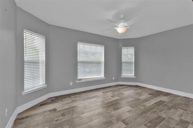 spare room with light wood-type flooring and ceiling fan