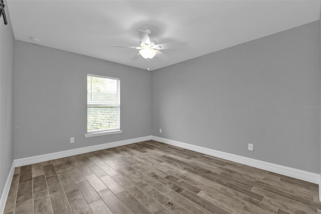 unfurnished room with hardwood / wood-style floors and ceiling fan