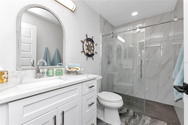 bathroom featuring walk in shower, vanity, and toilet