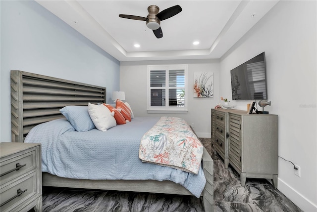 bedroom featuring a tray ceiling and ceiling fan