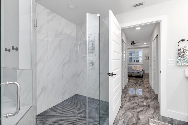 bathroom featuring ceiling fan and a shower with shower door