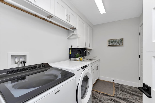 laundry room with washer and clothes dryer, cabinets, and sink