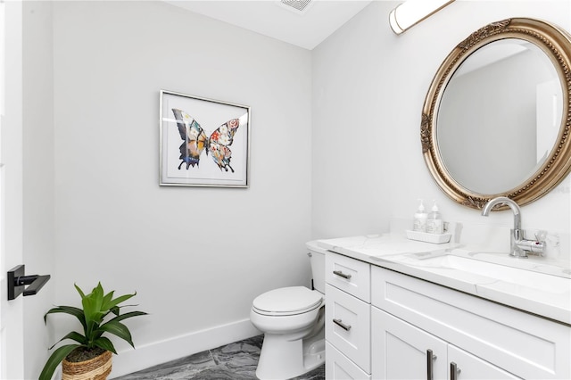 bathroom with vanity and toilet