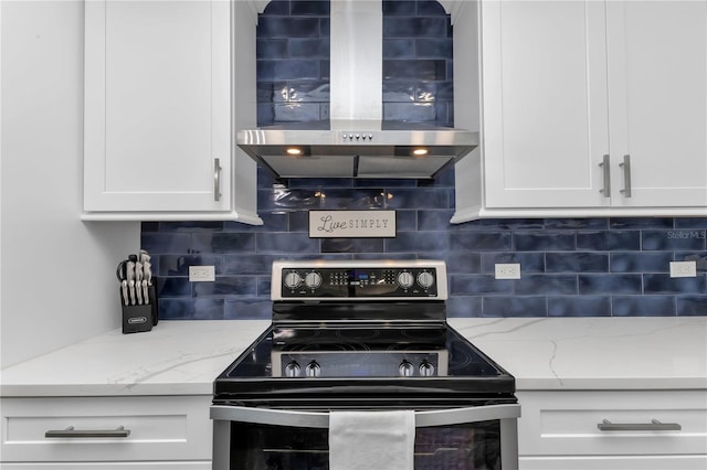 kitchen with backsplash, wall chimney exhaust hood, white cabinetry, and stainless steel range with electric cooktop