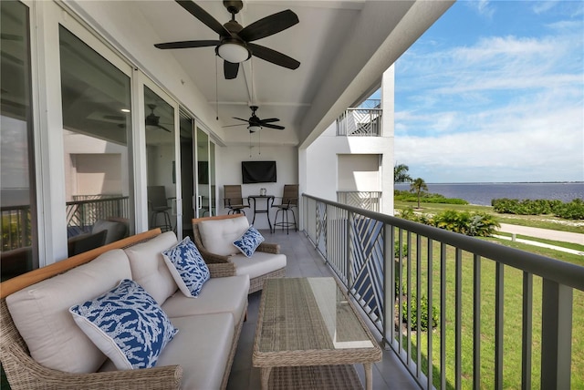 balcony with an outdoor hangout area, a water view, and ceiling fan