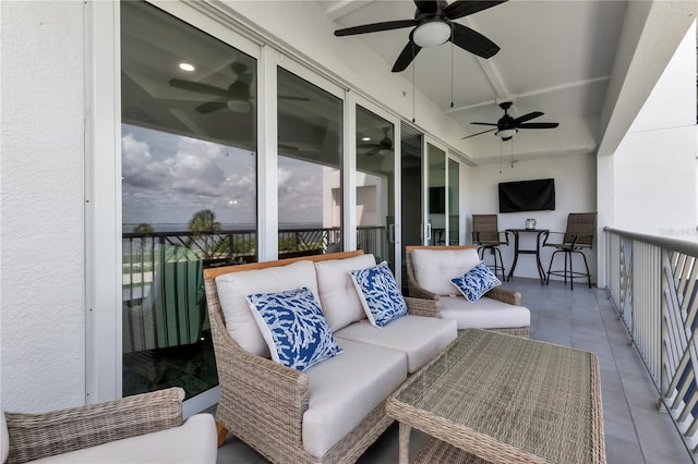 balcony featuring a patio, ceiling fan, and outdoor lounge area