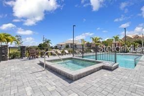 view of pool with a hot tub